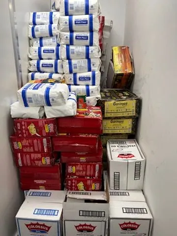 Flour, cooking oil and pantry staples stored ready for emergency food relief hampers