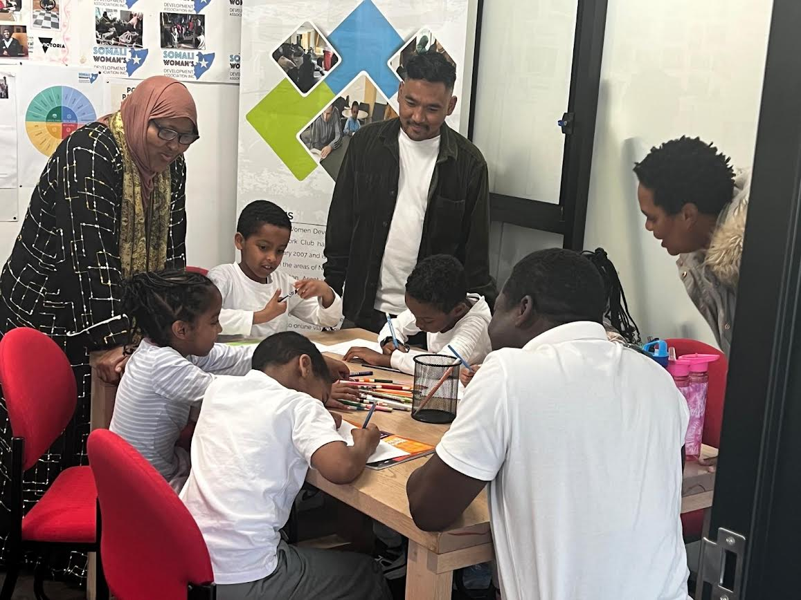 SWDA Homework Club children drawing and learning together with tutors and mentors