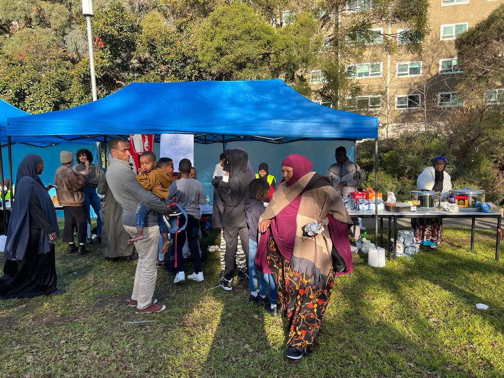 Families gathered under marquees at an SWDA community festival and food stall