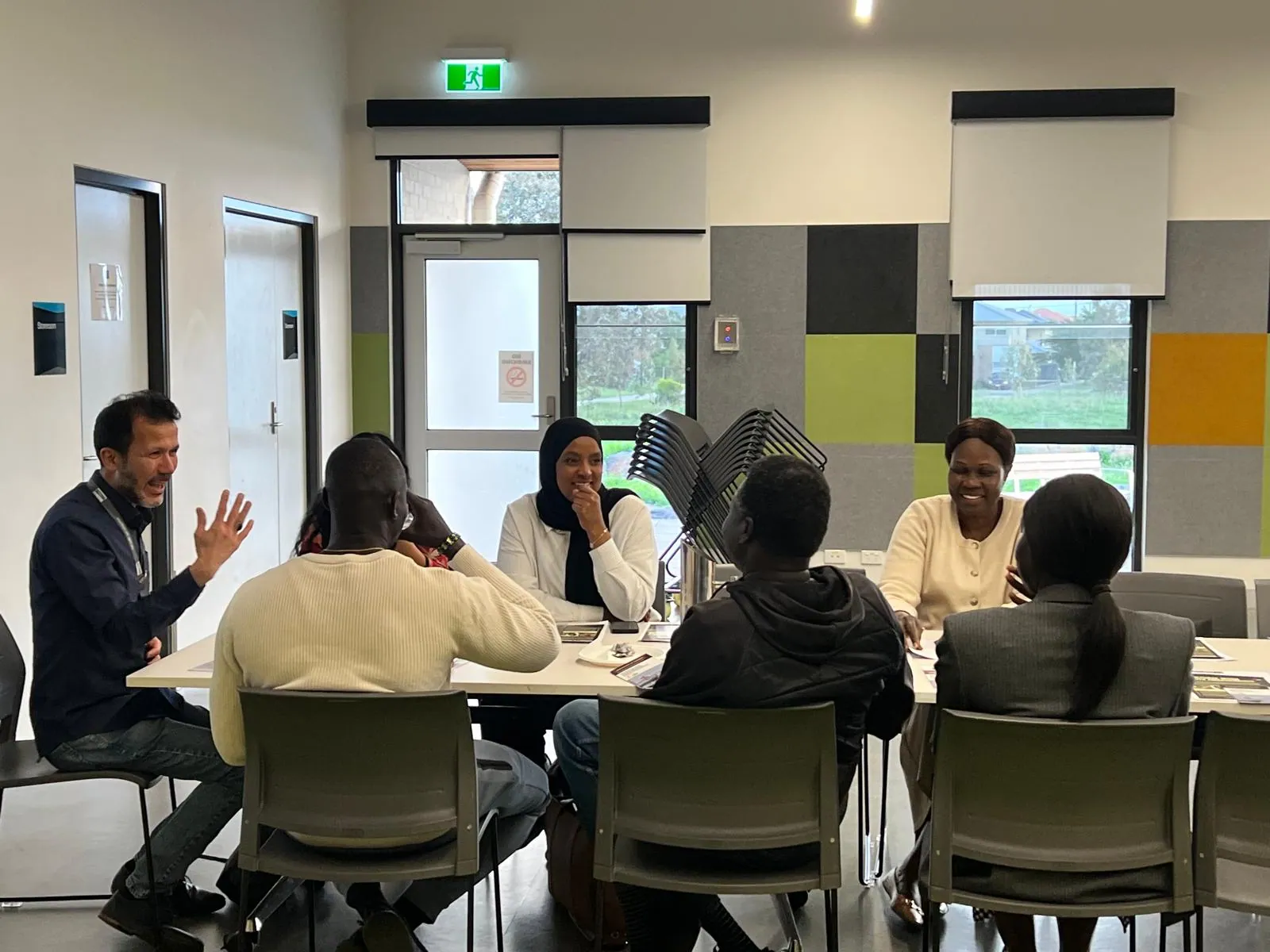 Community members meeting around a table at SWDA