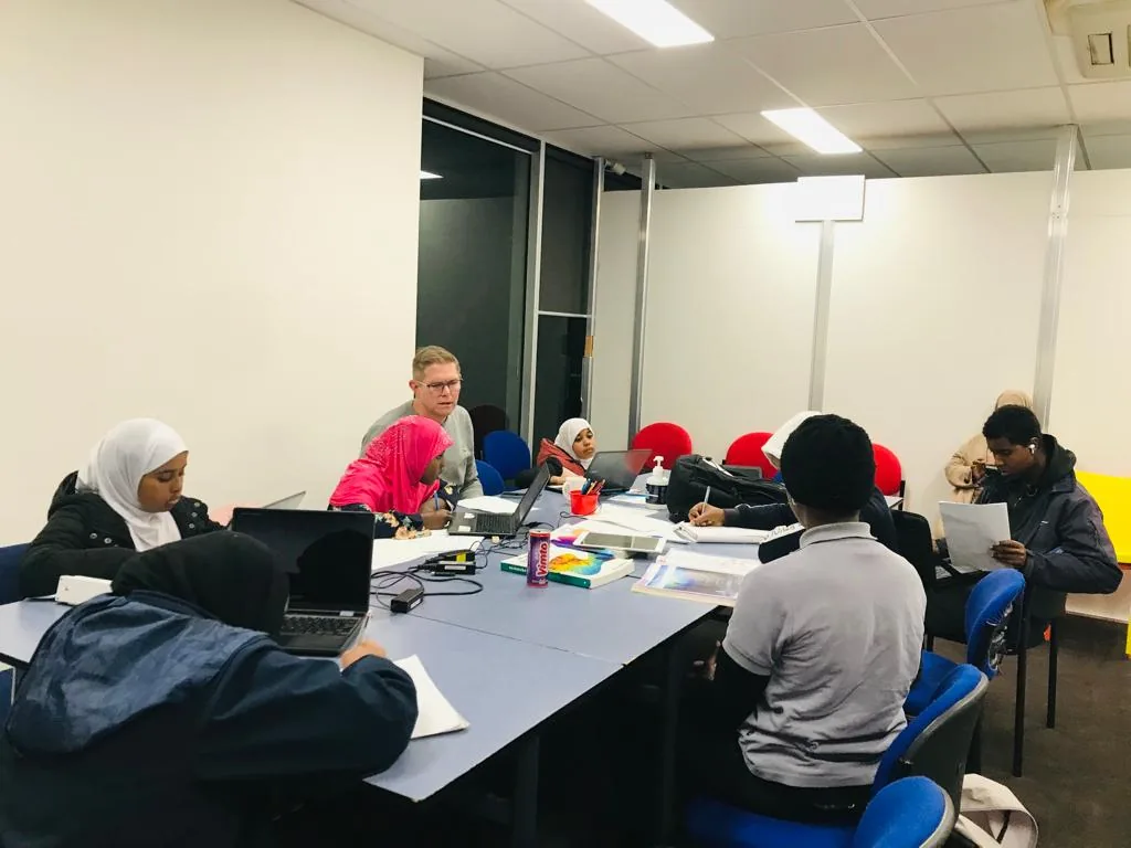 Participants learning together around a table during an Employment Brokers training session