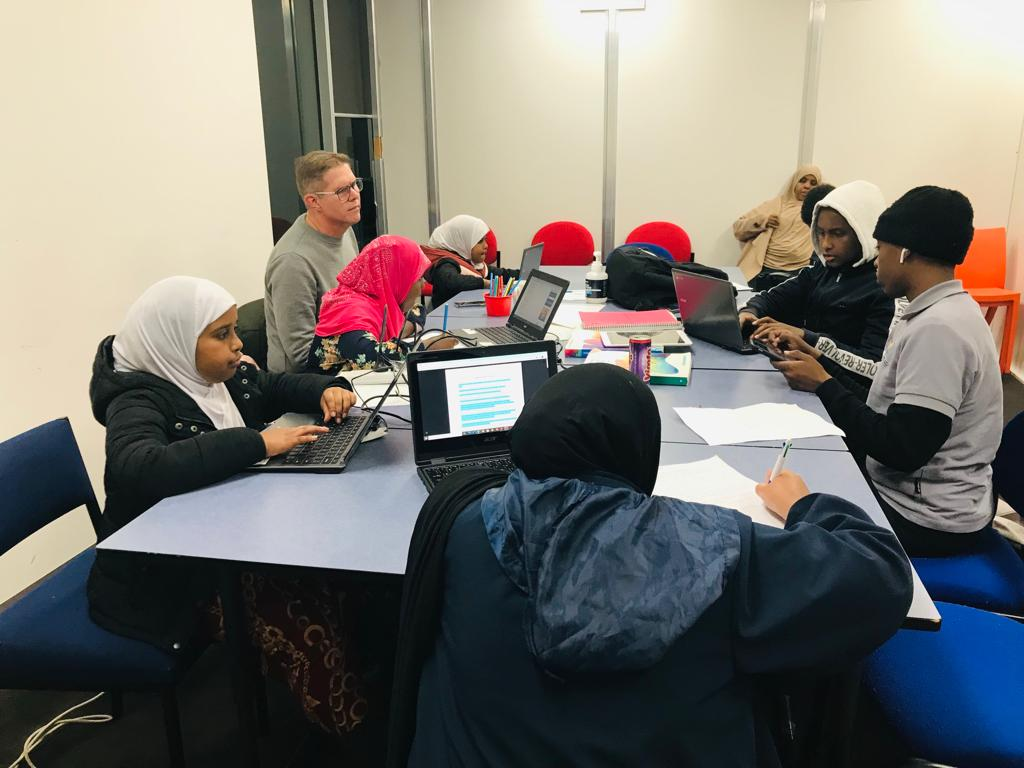 SWDA Homework Club participants learning together with mentors
