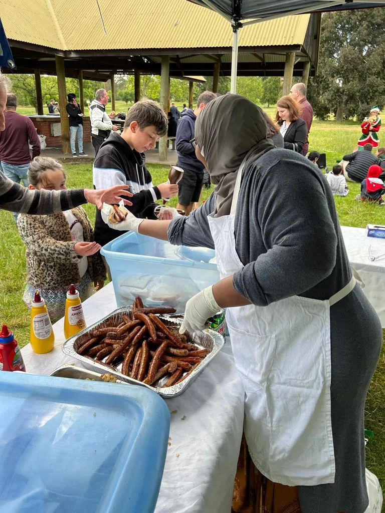 Community members serving food during an Employment Brokers community event
