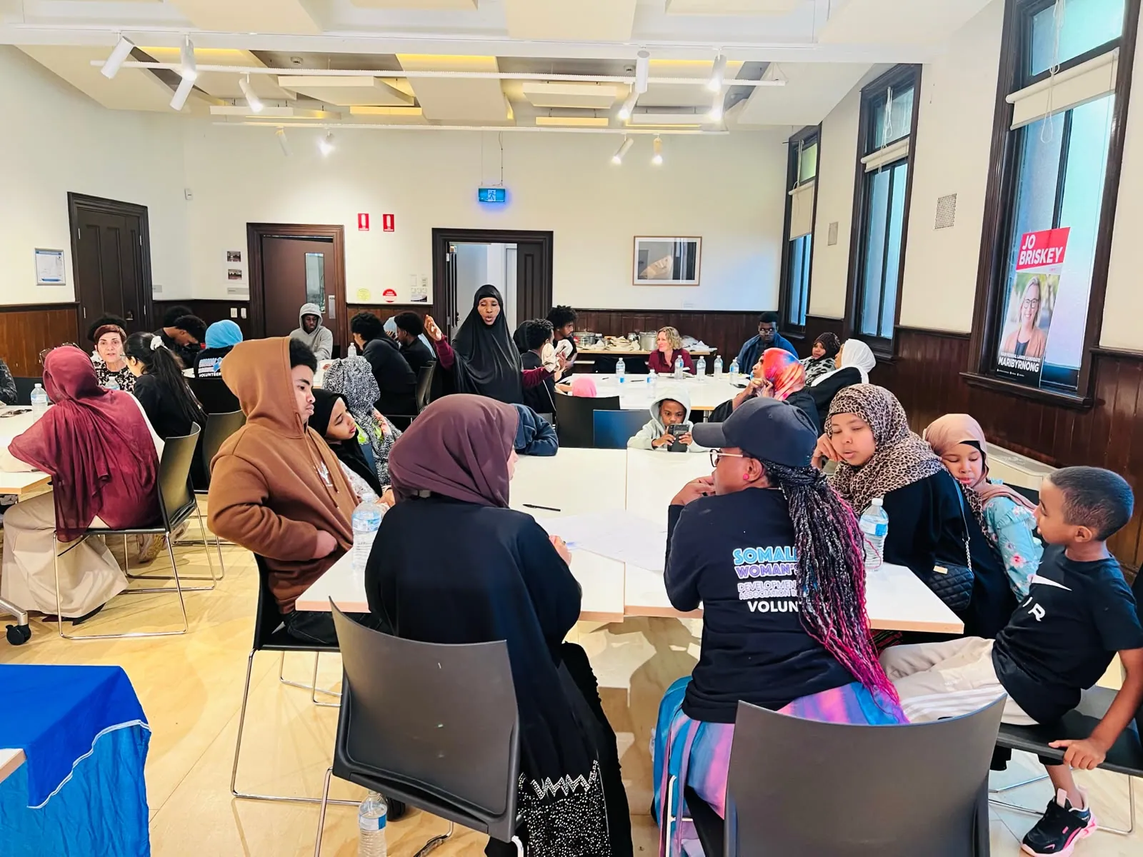 Community members and volunteers at an SWDA community forum and shared meal
