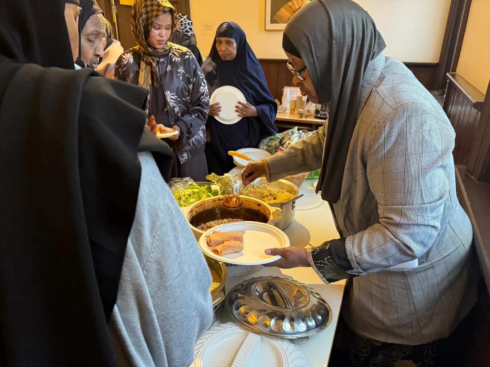 SWDA volunteer serving cooked meals to community members at a shared lunch
