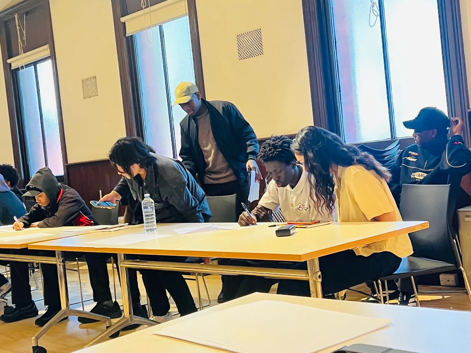 Jobseekers completing workshop activities with support from Employment Brokers staff