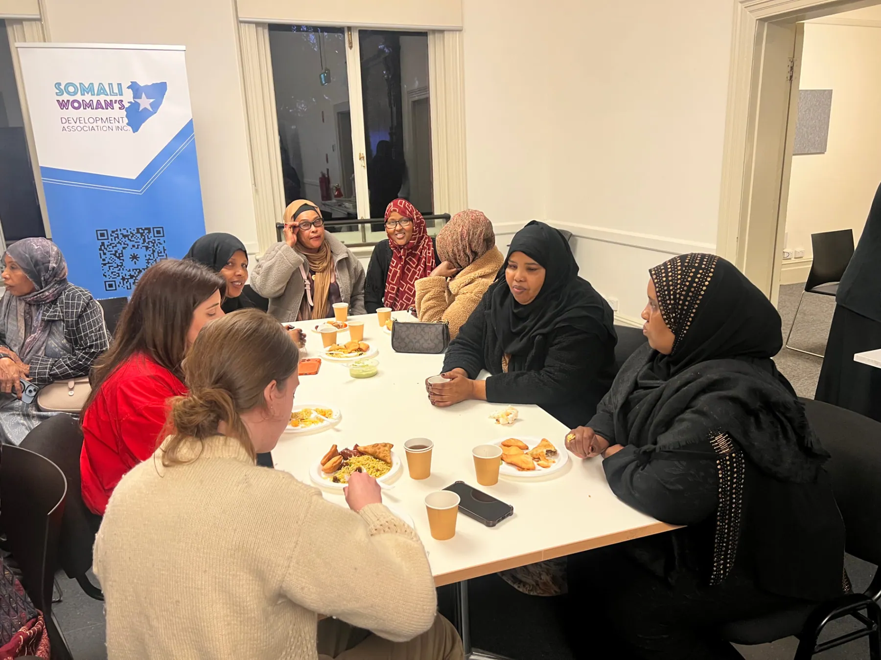 Community women sharing a meal and conversation at an SWDA information evening