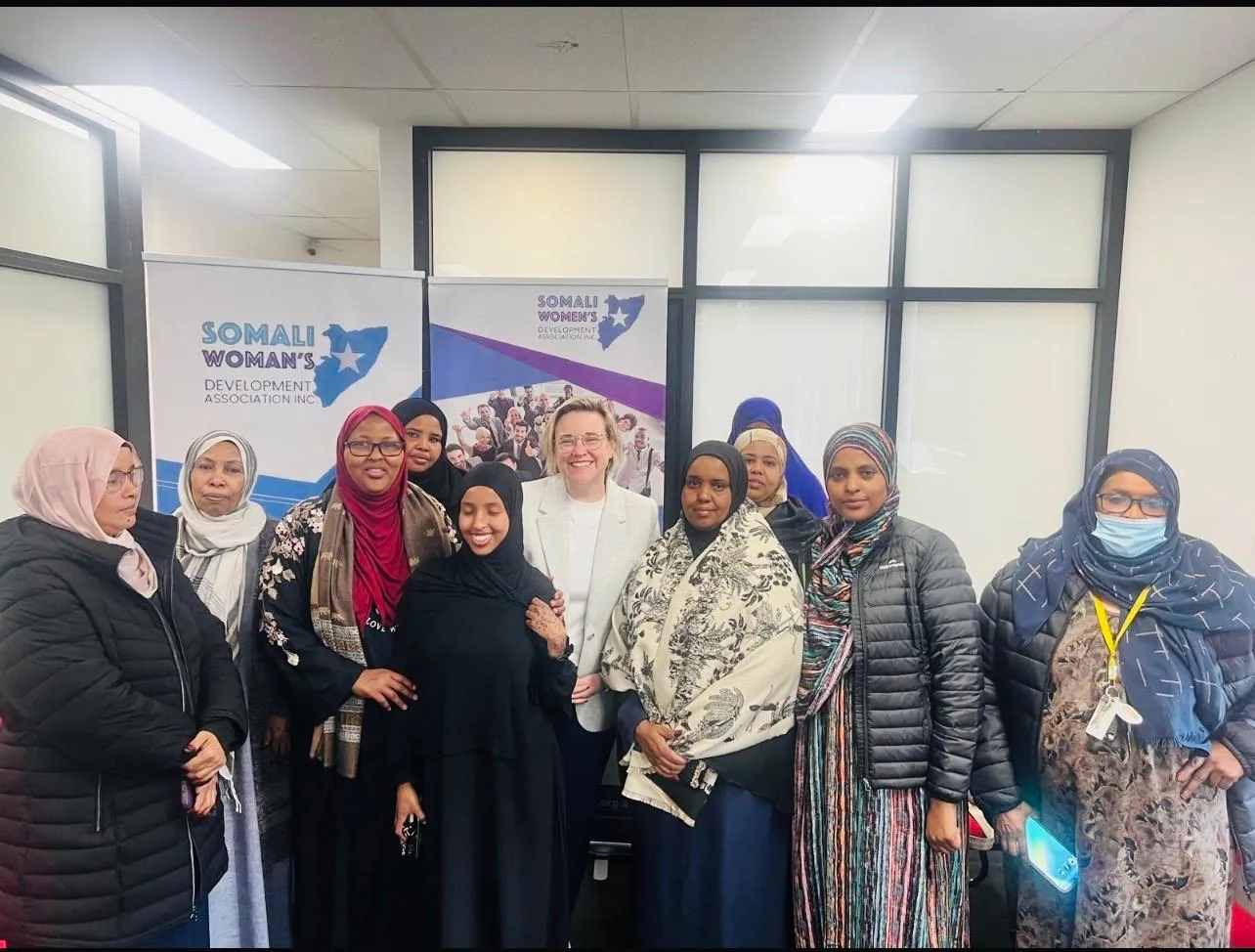 SWDA community members and guests together at a SWDA program event with branded banners
