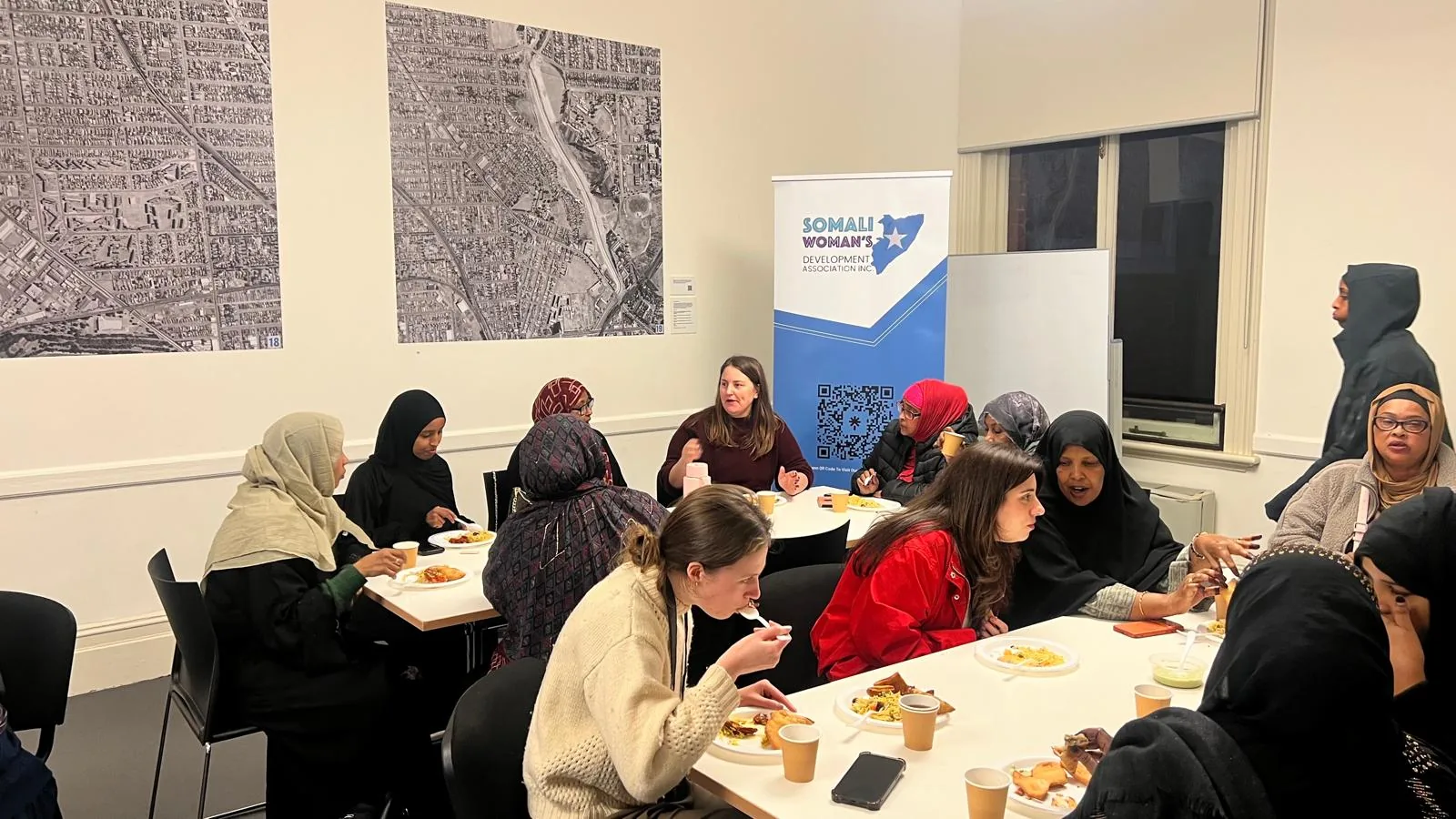 Community women sharing a meal and conversation at an SWDA and SCoA community session