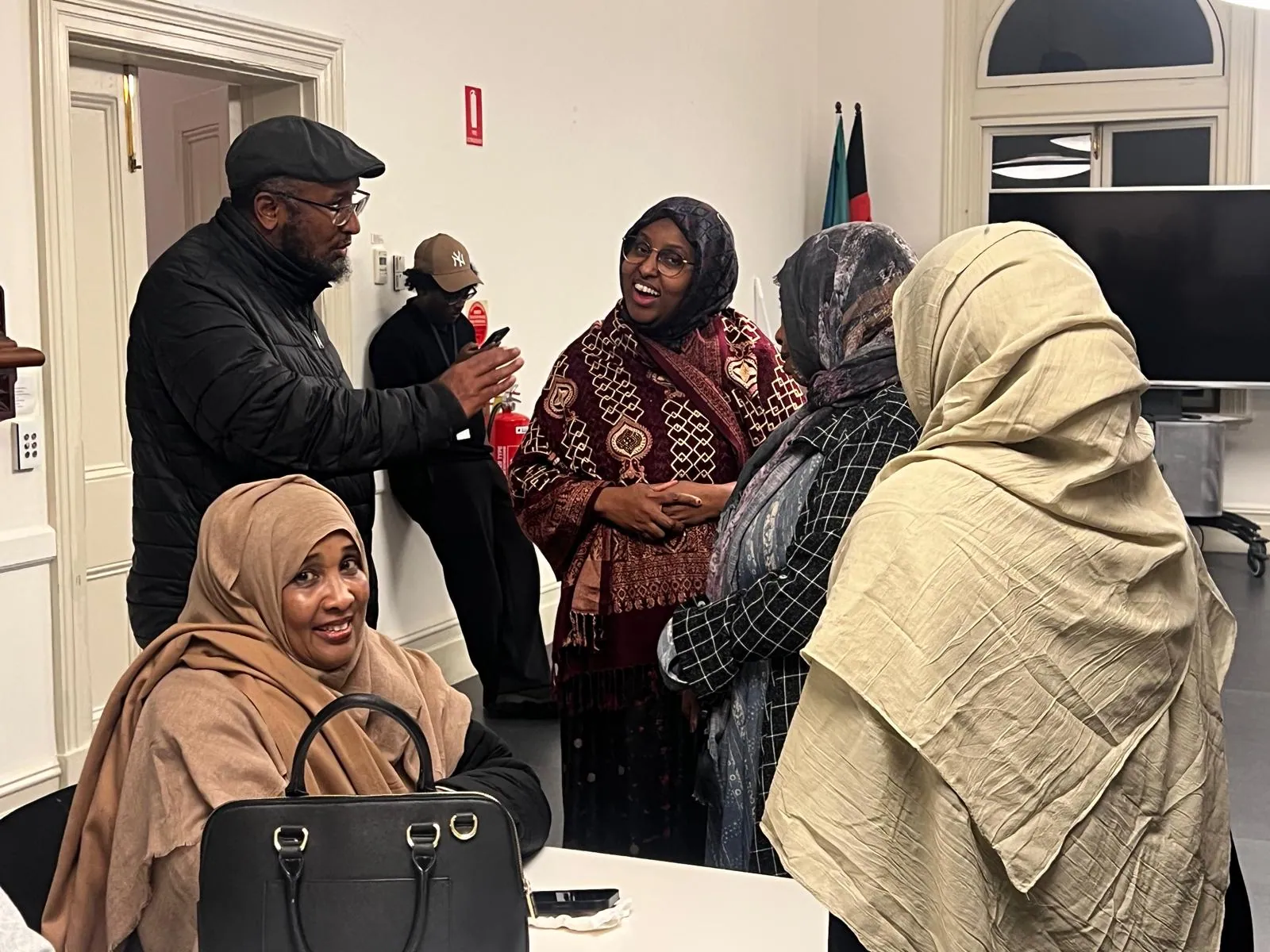 SWDA elders and community leaders talking together at an evening event