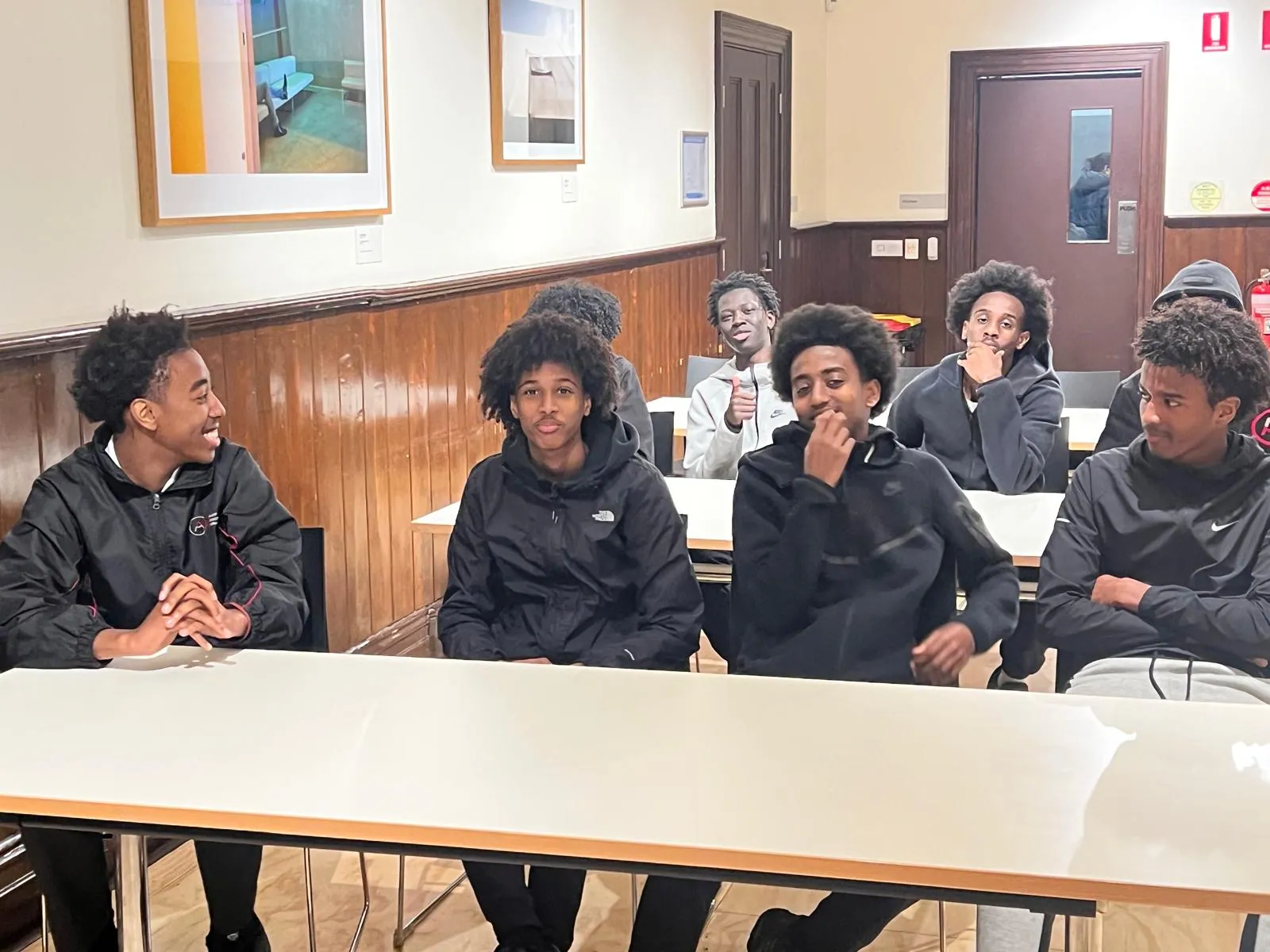 Homework Club students seated together during an evening group session