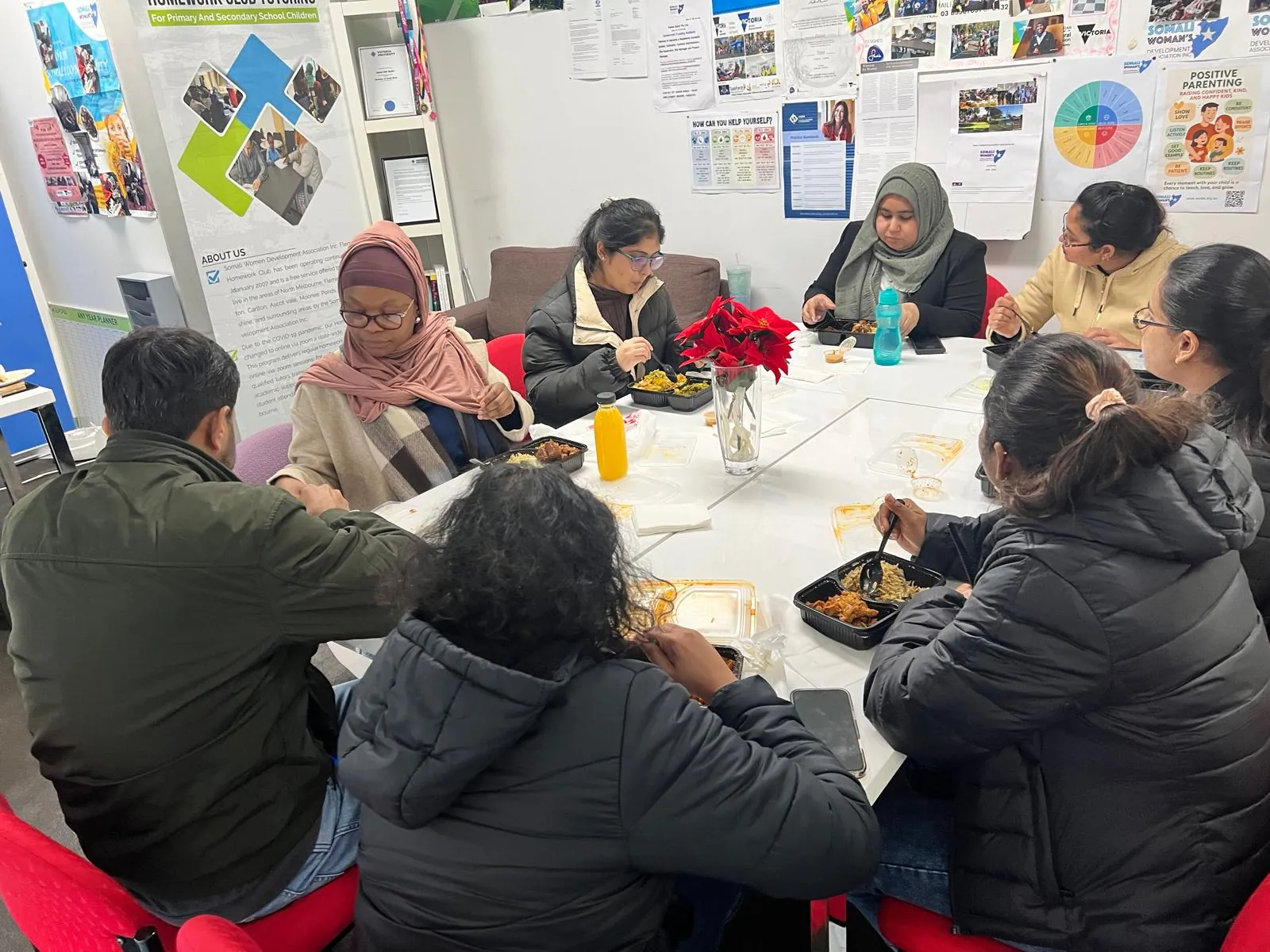 Homework Club tutors and staff sharing a meal together at the SWDA office