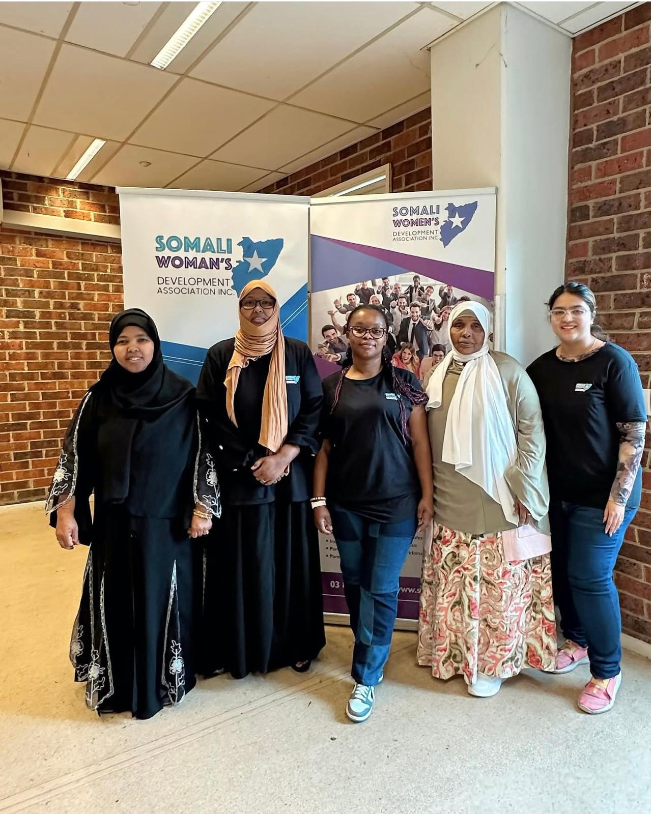 SWDA Employment Brokers team beside program banners