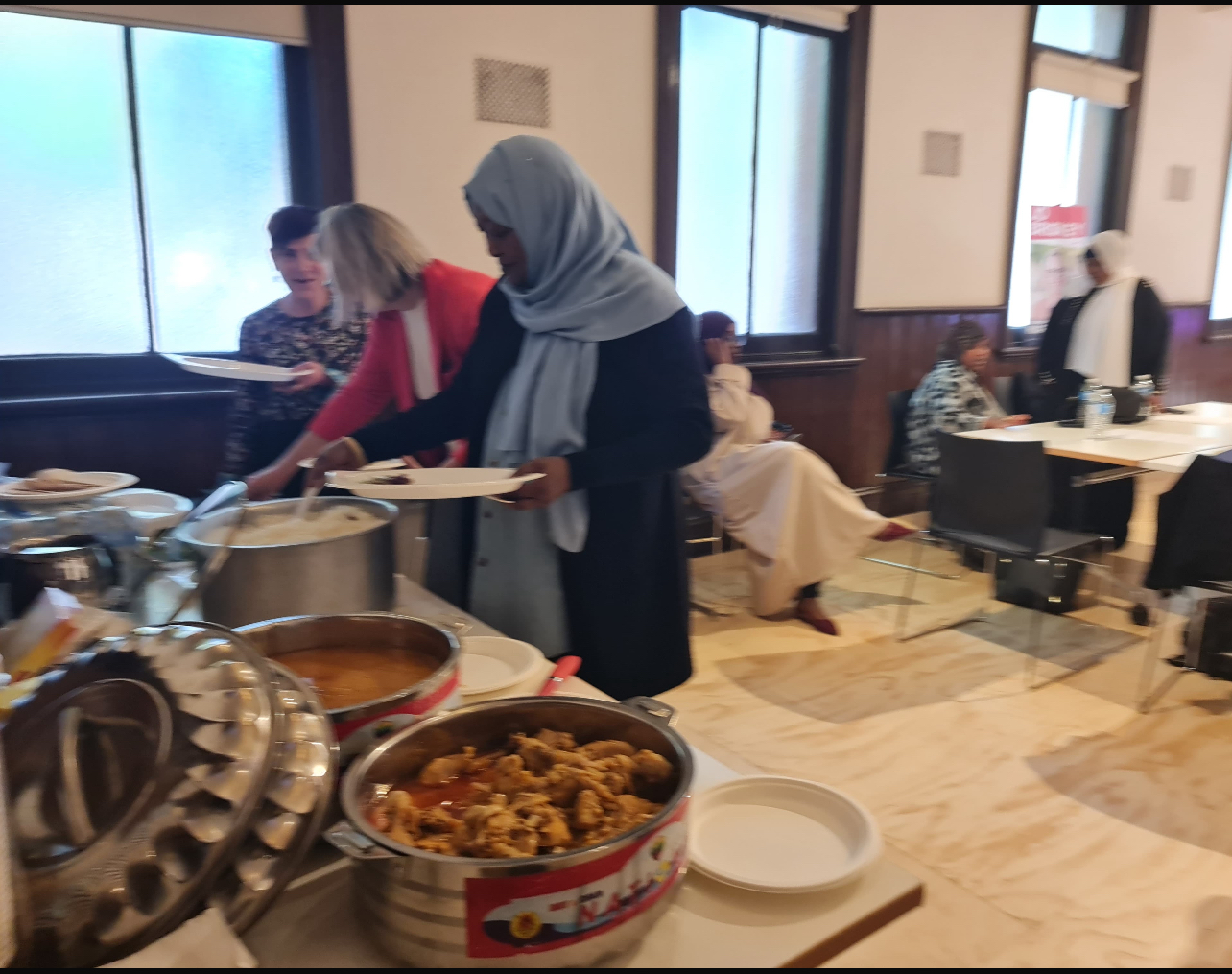 SWDA staff and guests serving traditional food at a community event