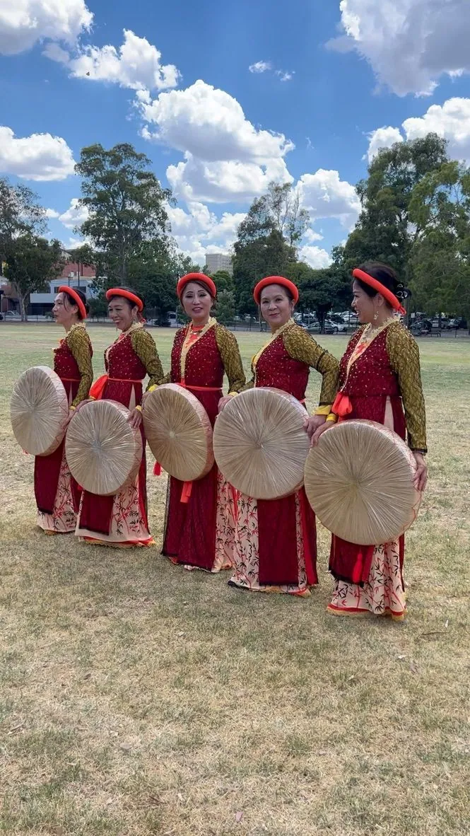 Vietnamese community dancers in traditional dress performing at a multicultural festival