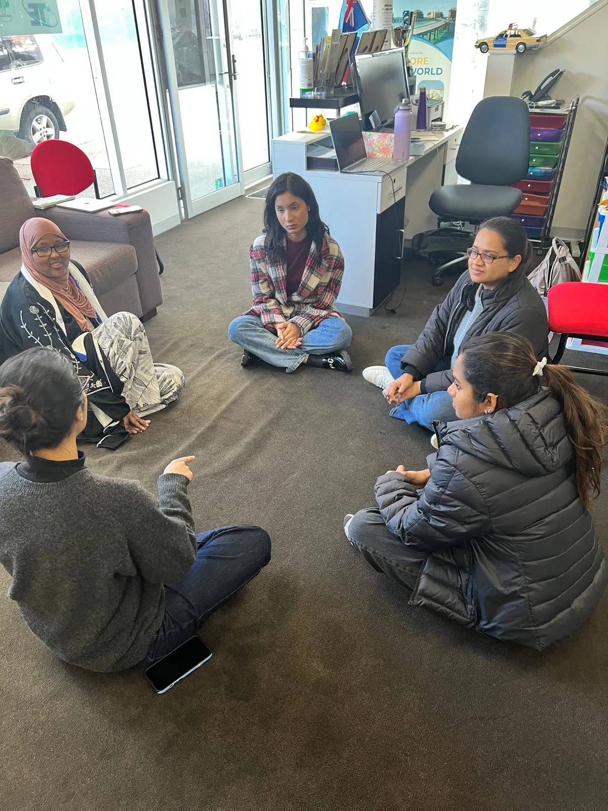 Community members in a guided group discussion circle at SWDA
