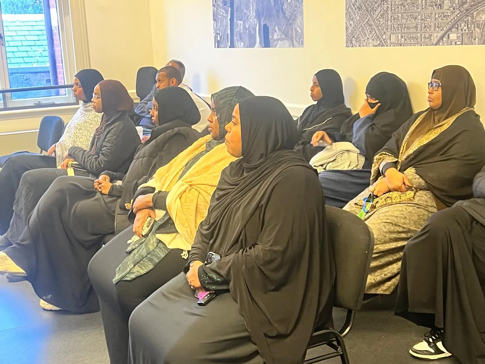 Women community members listening attentively at an SWDA workshop session