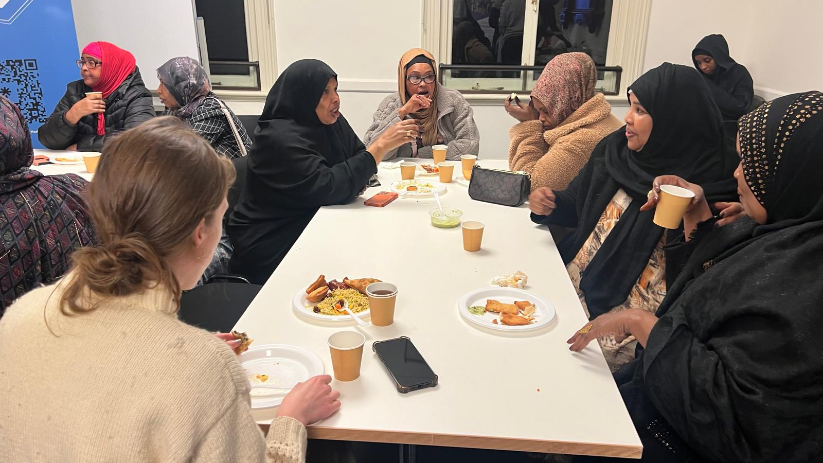 Women sharing food and conversation at an SWDA gathering