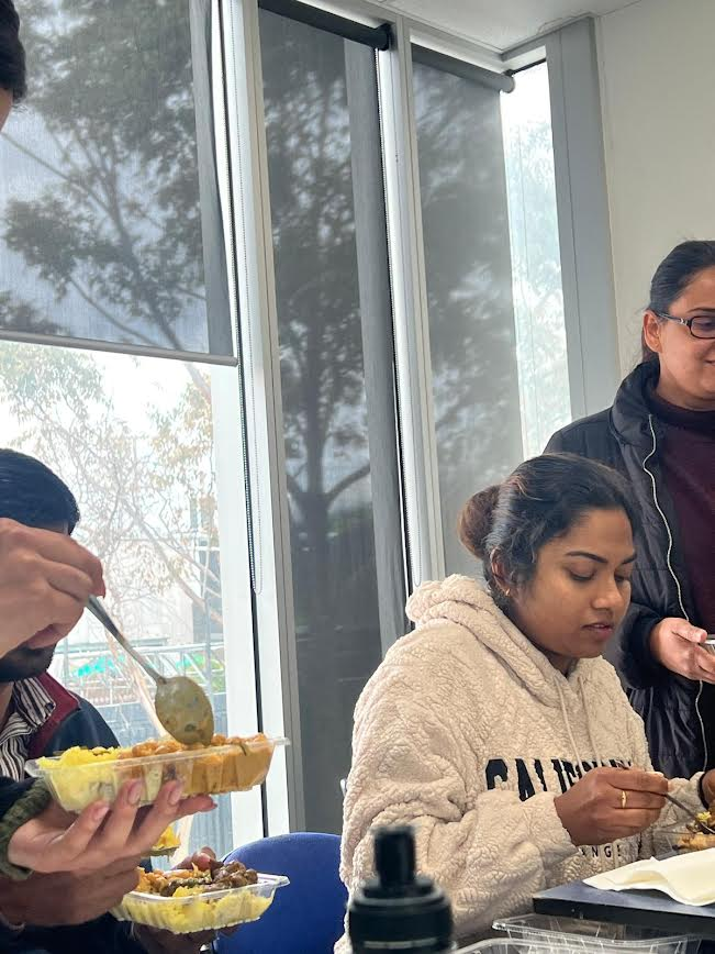 University placement students sharing a meal during an SWDA community session