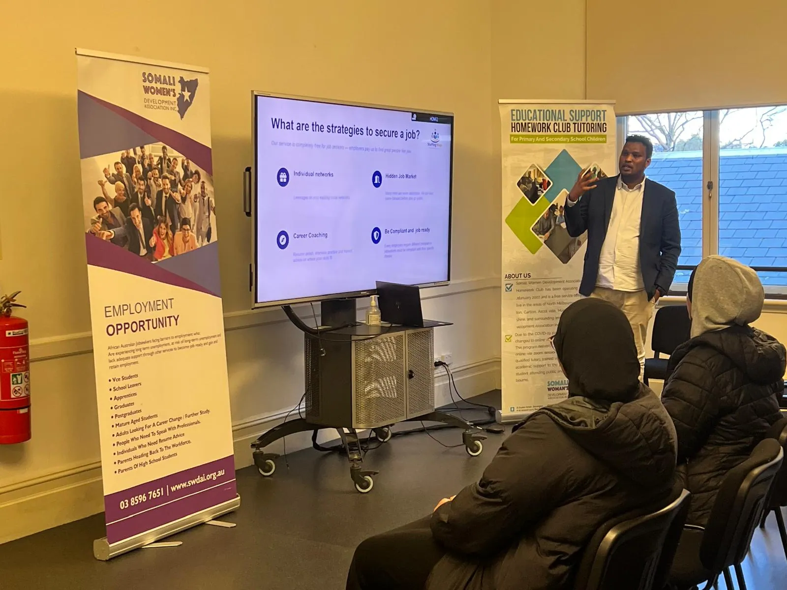 Employment facilitator presenting job-seeking strategies to workshop participants