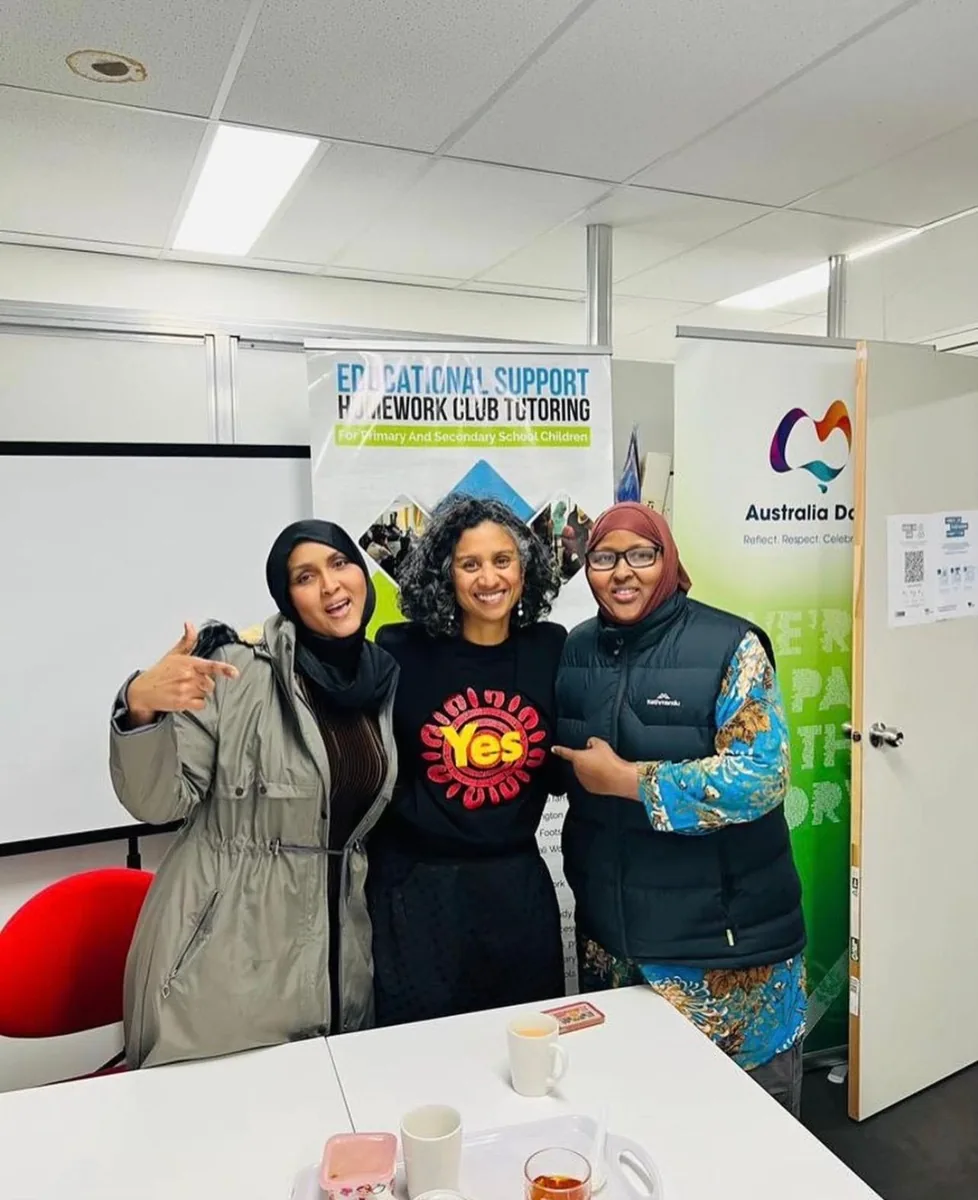 Three community leaders together at an SWDA Homework Club and community event